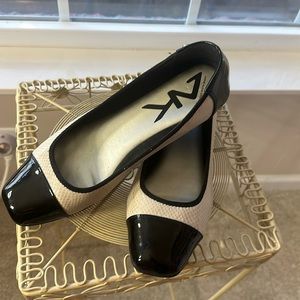 Ann Klein, size 10, patented leather-toed black and cream flexible loafers.